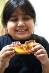 girl-eating-toast-holding-52443847.jpg